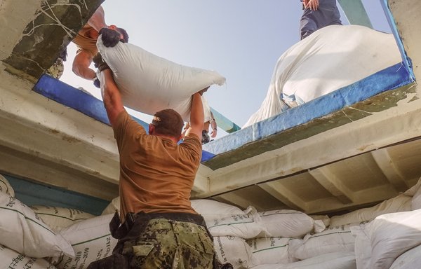 Sailors from guided-missile destroyer USS The Sullivans inventory a large quantity of urea fertiliser and ammonium perchlorate discovered on a fishing vessel intercepted by US naval forces while transiting international waters in the Gulf of Oman on November 9. [US Navy]
