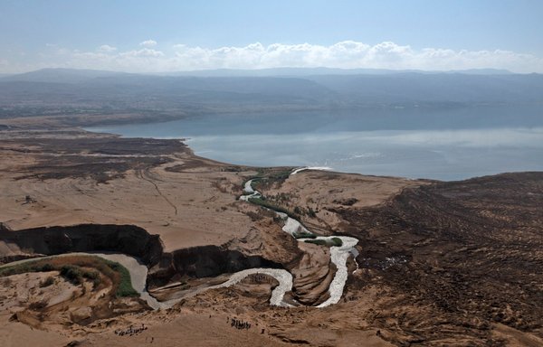 A file photo taken October 14 shows the hills near the Jordan River where the stream pours into the Dead Sea, near the West Bank city of Jericho. Israel and Jordan on November 17 signed an agreement in Egypt to clean up the river, on the sidelines of the COP27 climate summit. [Menahem Kahana/AFP]