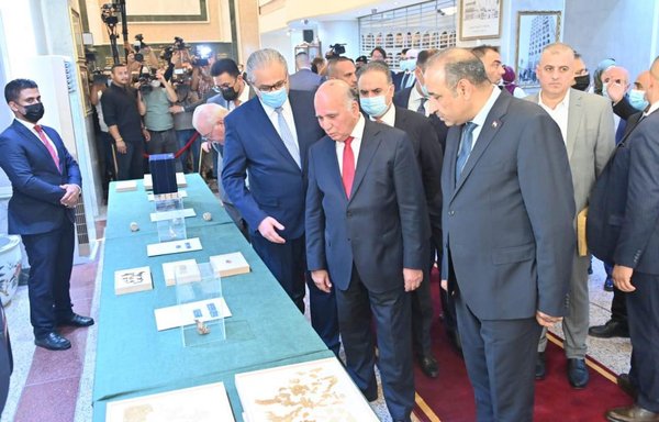 Iraqi officials August 3, 2021, inspect artefacts that were returned to Iraq from the United States. [Iraqi Ministry of Culture]