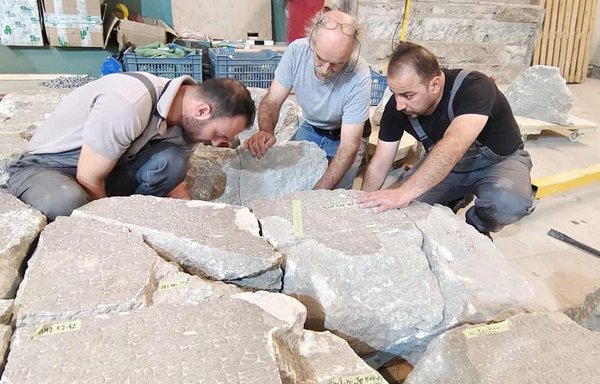 A team of Iraqi and French experts on September 28, 2021, repair archaeological artefacts destroyed by ISIS when it swept through the city of Mosul in 2014. [Iraqi Antiquities and Heritage Authority]