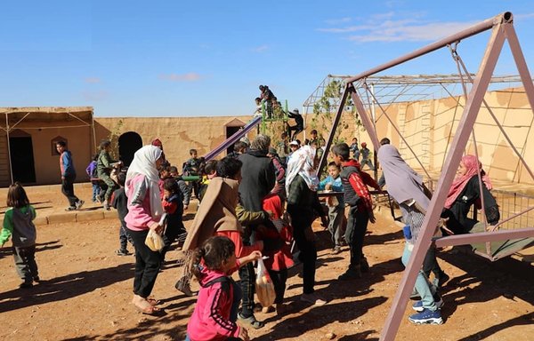 Al-Rukban camp residents are seen here in a photo posted online on June 25. Activists say there are growing concerns that civilians in the camp could be in danger in view of the Iranian and Russian movements. [Al-Rukban camp Facebook page]