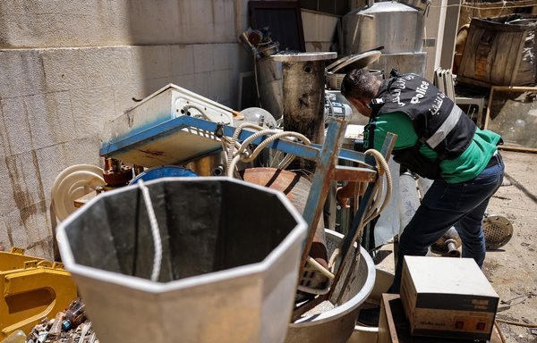 A Lebanese judicial police official inspects confiscated instruments for Captagon pill manufacturing at the judicial police headquarters in the Bekaa Valley city of Zahle on July 21. [Joseph Eid/AFP]