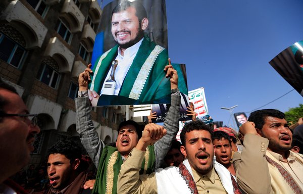 Supporters of Yemen's Houthis raise portraits of the group's leader, Abdul-Malik al-Houthi, during a rally in Sanaa on March 26. [Mohammed Huwais/AFP]
