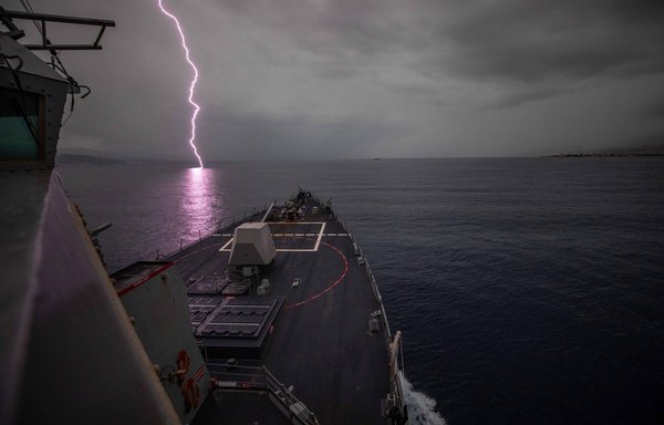 Lightning strikes the water as the USS Roosevelt transits the Strait of Messina on November 20. [US Navy]