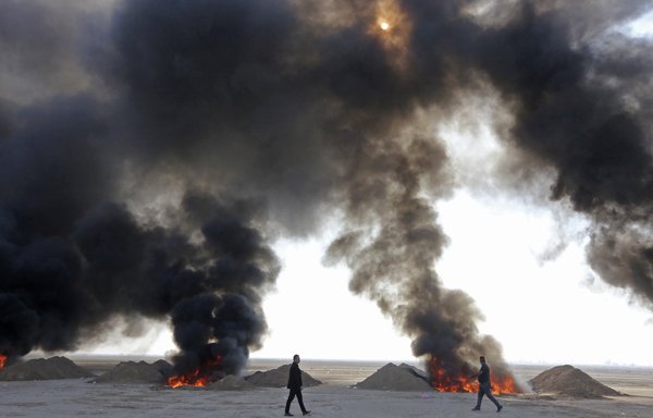 Iraqi government officials destroy nearly six tonnes of drugs, some of which had been in storage for several years, in Baghdad's Nahrawan area on December 18. [Sabah Arar/AFP]
