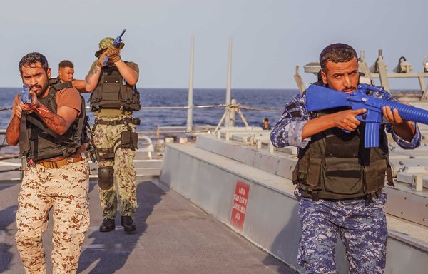 A multinational boarding team, from navies and coast guards for the United States and Middle Eastern nations, rehearses vessel boarding procedures aboard guided-missile destroyer USS The Sullivans in the Gulf of Oman on December 8. The US Navy's 5th Fleet conducted a two-week multinational vessel boarding integration event with regional partners to deepen maritime security co-operation. [US Navy]