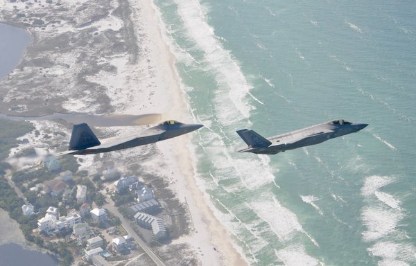 An F-22 Raptor flies alongside an F-35 Lightning II over the Emerald Coast on May 15, 2020. [US Air Force]