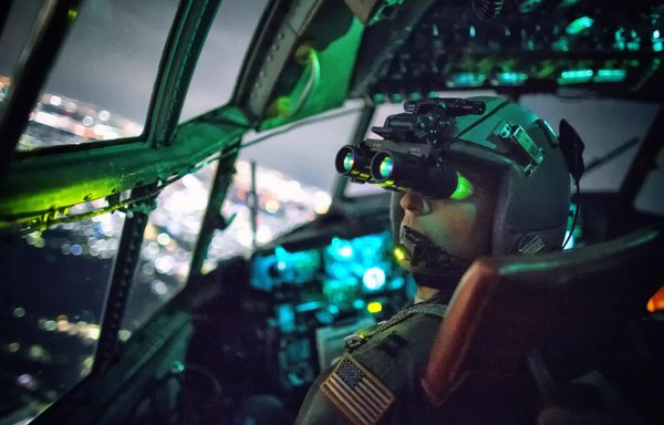 A US pilot performs a visual confirmation with night vision goggles during a training mission. Similar technology is used in the HC-130 Combat Kings. [US Air Force]