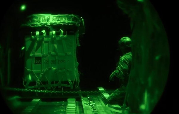 An aircrew member performs an airdrop out of an HC-130 in 2021. [US Air Force]