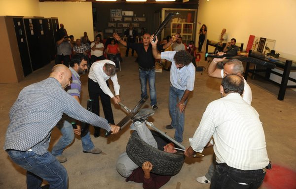 A torture method known as al-Doulab (car tire) and used in Syrian detention prisons is seen here in a scene from a play based on the testimonies of former detainees. [UMAM Documentation & Research]