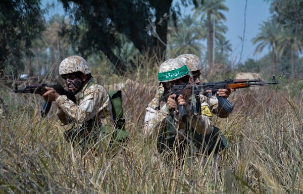 Harakat al-Nujaba elements are seen here in a propaganda photo circulated by the militia. [Harakat al-Nujaba/Twitter]