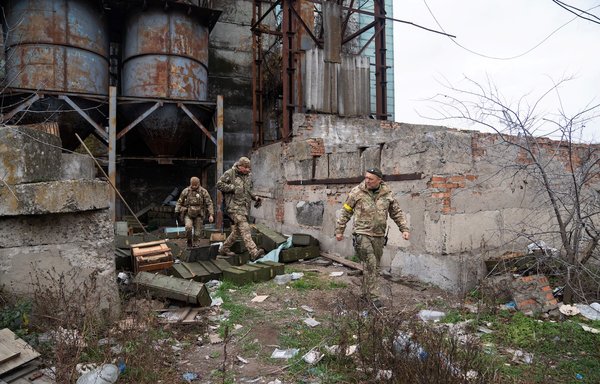 A Ukraine police demining unit checks the area of a grain elevator facility used as a Russian military base during the occupation in Snihurivka, Mykolaiv region, on November 16. [Ihor Tkachov/AFP]