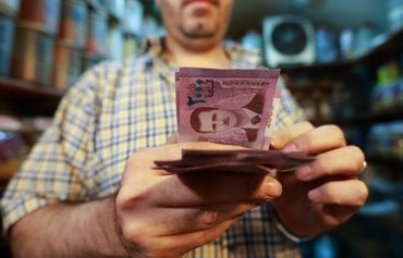 Syrian regime and Hizbullah cronies drain Lebanon's dollars