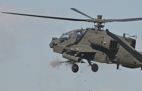 A South Korean Army Apache helicopter fires during a live fire military exercise during the Defence Expo Korea (DX Korea) at a training field near the demilitarised zone separating the two Koreas in Pocheon last September 20. [Anthony Wallace/AFP]
