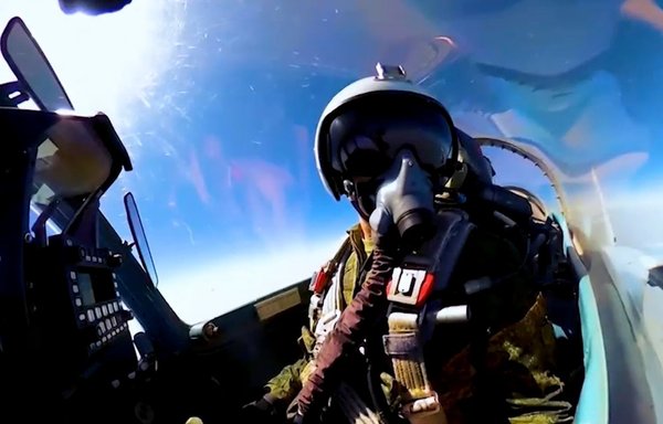 A screenshot from a Russian Ministry of Defence video shows a pilot flying an Su-35 and some of the plane's controls.