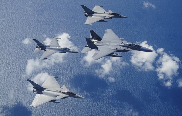 Singaporean F-15s and F-16s fly along with French Rafale fighter jets above the South China Sea on January 20. [Singapore Air Force]