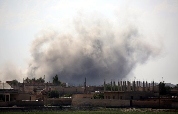 Smoke billows in al-Sinaa district in the Syrian city of al-Raqa on June 21, 2017, during an offensive to retake the city from ISIS. [Delil Souleiman/AFP]
