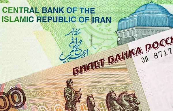 Russian and Iranian banknotes are seen here, illustrating a new agreement between the Iranian and Russian central banks that will enable 700 Russian banks to interact with Iranian banks. [Sigmamedia]