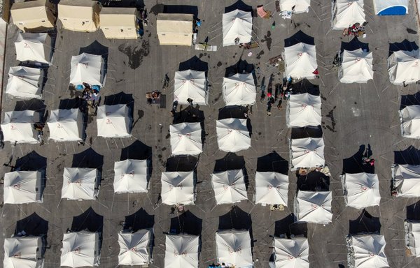 An aerial picture shows a makeshift shelter for people who were left homeless, near the Syrian opposition-held town of Jindayris on February 9, two days after a deadly earthquake hit Türkiye and Syria. [Rami al-Sayed/AFP]