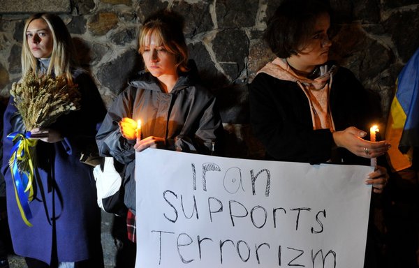 People demonstrate outside the Iranian embassy in Ukraine on October 17 in Kyiv, after the city was hit by swarms of kamikaze drones sold by Iran to Russia, leaving at least three dead. [Sergei Chuzavkov/AFP]
