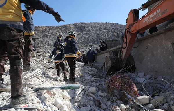 Members of the White Helmets search for survivors under the rubble in rural Idlib on February 8. [White Helmets]