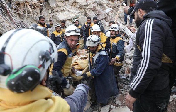 Members of the White Helmets transfer a man they recovered alive from under the rubble in rural Idlib on February 8. [White Helmets]