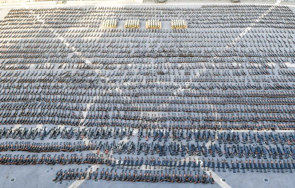 Seized weapons are displayed on the flight deck of a US Navy ship. [US Navy]