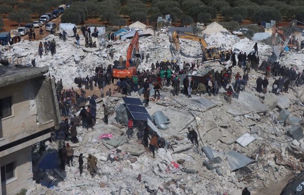 Civilians and volunteers search for survivors under the rubble in the Idlib province town of Basina on February 8. [White Helmets]