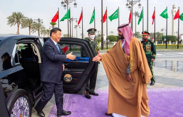 Saudi Crown Prince Mohammed bin Salman greets Chinese President Xi Jinping, in Riyadh, in December. [Bandar Al-Jaloud/Saudi Royal Palace/AFP]