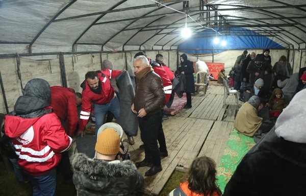 Kurdish Red Crescent volunteers distribute aid to civilians in a shelter after an earthquake hit Syria on February 6. [Kurdish Red Crescent]