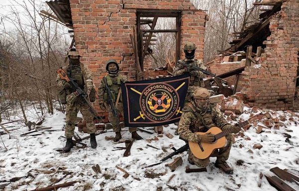 Russian Wagner Group mercenaries celebrate amid the ruins of a destroyed house in Ukraine on February 2. [Reverse Side of the Medal Telegram account]