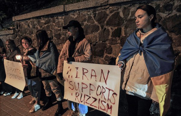 People demonstrate outside the Iranian embassy in Ukraine on October 17 in Kyiv, after the city was hit by swarms of 'suicide drones' sold by Iran to Russia, leaving at least three dead. [Sergei Chuzavkov/AFP]