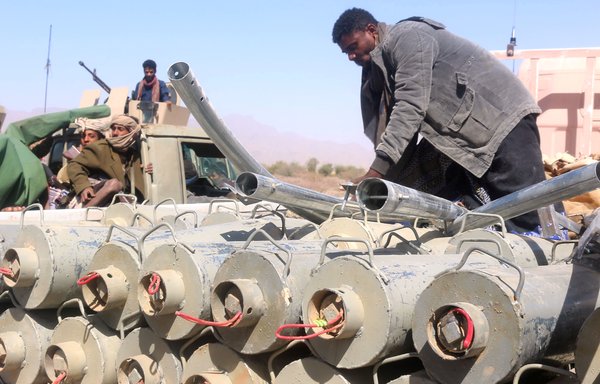 Yemeni pro-government fighters surround ordnance removed from the district of Harib, Marib province, on January 25, 2022, after the Houthis were expelled from it. [Saleh al-Obeidi/AFP]