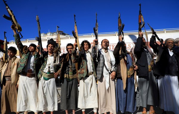 Supporters of the Houthis brandish weapons as they rally in Sanaa on January 27, 2022. [Mohammed Huwais/AFP]