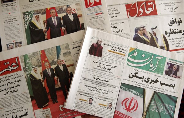 Newspaper headlines in Tehran on March 11 tell of the China-brokered deal between Iran and Saudi Arabia, signed in Beijing the previous day. [Atta Kenare/AFP]