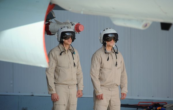 Russian fighter pilots stand under a Su-35 fighter jet at the Russian military base of Hmeimim in Latakia, Syria, on September 26, 2019. [Maxime Popove/AFP]