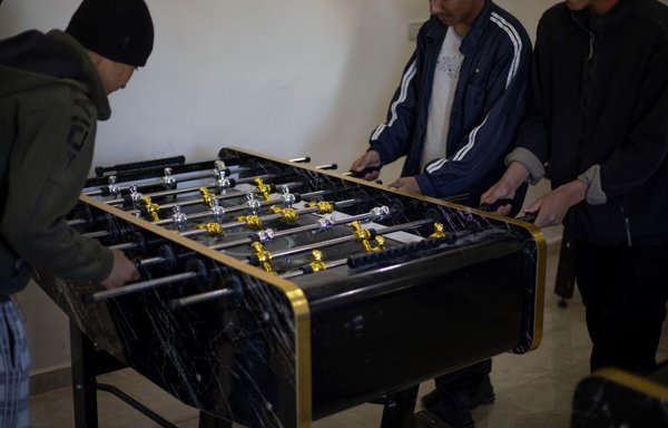Children of ISIS foreign fighters play table football at the Orkesh rehabilitation centre in Qamishli on March 7. [AFP]