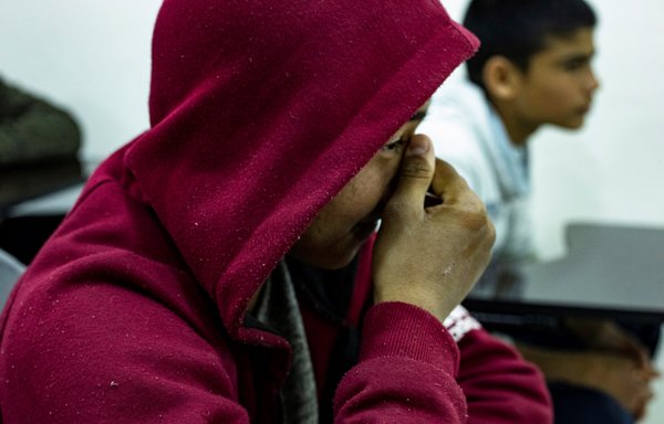 The son of an ISIS foreign fighter attends a class at the Orkesh rehabilitation centre in Qamishli on March 7. [AFP]