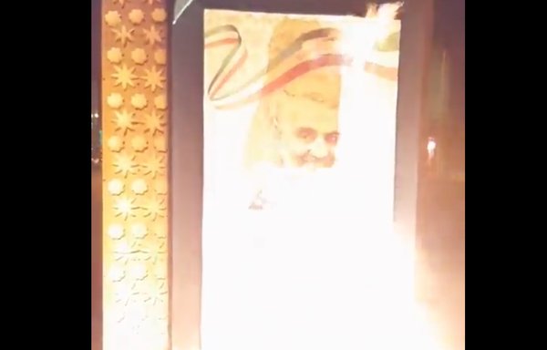 A poster of the late IRGC Quds Force commander, Qassem Soleimani, is set alight in protests that reignited during the traditional fire festival in the days before Nowruz. [Screen grab/Social media]