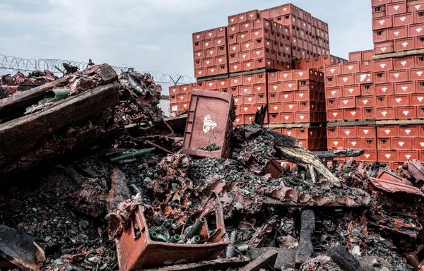 A general view of debris from beer crates at the MOCAF brewery in Bangui, Central African Republic, on March 10, following an arson incident blamed on Wagner mercenaries. [Barbara Debout/AFP]