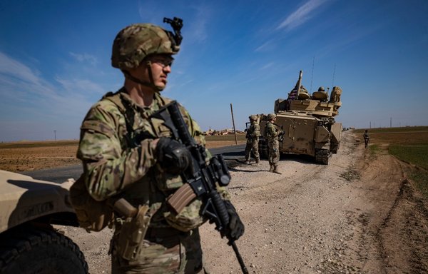 US troops patrol in the countryside of Syria's al-Hasakeh province near the Turkish border, on February 18. [Delil Souleiman/AFP]