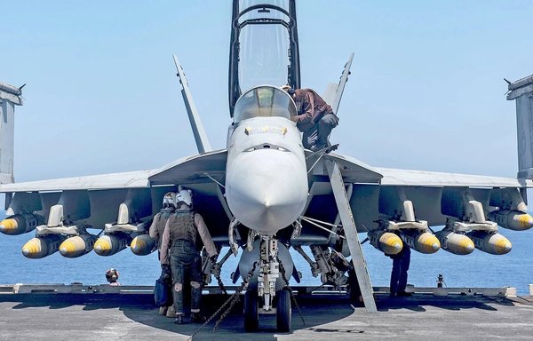 A fully loaded US F-18 readies for a mission over Syria on March 23. [Air Power/Twitter]
