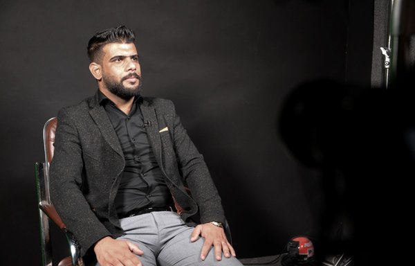 Moslem Hmeid, a 27-year-old law student, shares his memories of what he endured under ISIS rule during a filmed interview with members of the Mosul Eye project, in Mosul on February 27. [Zaid al-Obeidi/AFP]