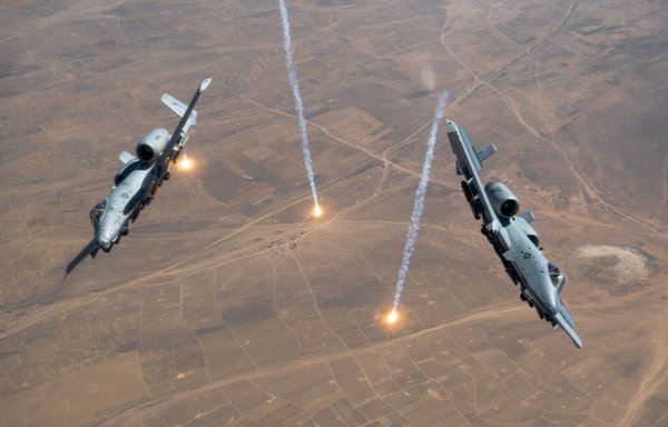 Two A-10s releasing countermeasures. [US Air Force]