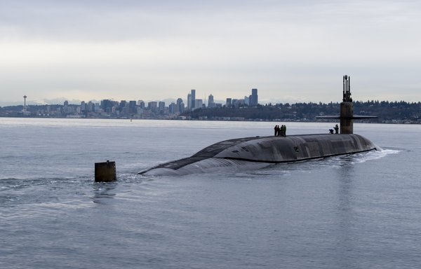 The Ohio-class ballistic missile submarine USS Louisiana (SSBN 743) transits Puget Sound past the Seattle skyline following a 41-month engineered refuelling overhaul at Puget Sound Naval Shipyard and Intermediate Maintenance Facility, February 9. [US Navy]