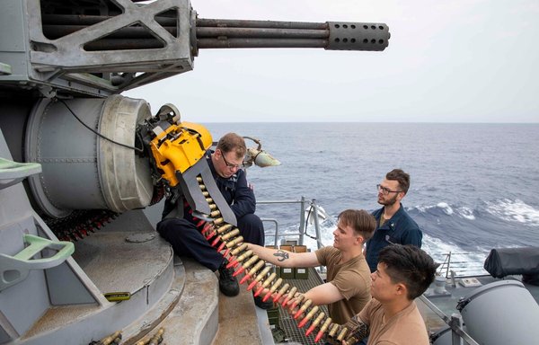 US Navy personnel load a high calibre gun onboard an Arleigh Burke destroyer during a live fire exercise in March. [US Navy]