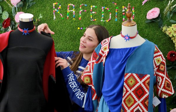 Iraqi tailor Sarah Nael inspects creations by the Rafedin project on March 12 in Amman. The project produces dresses, jackets, belts and ties that are sold in Amman and Italy. [Khalil Mazraawi/AFP]