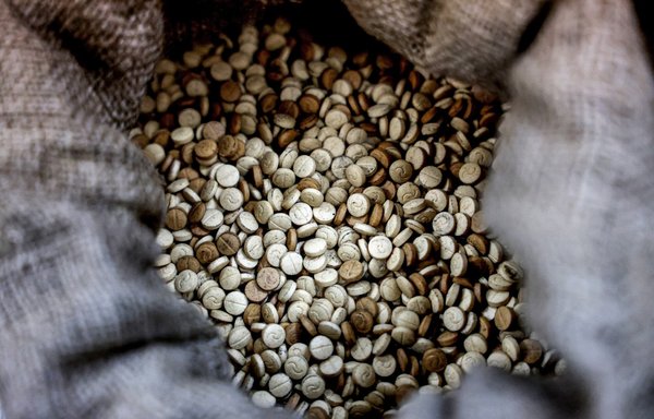 This picture taken on July 27 shows confiscated Captagon pills at the judicial police headquarters in the town of Kafarshima, Lebanon, south of Beirut. The Captagon trade has turned Syria into the world's latest narco-state, and sunk deep roots in neighbouring Lebanon as its economy has collapsed. [Joseph Eid/AFP]