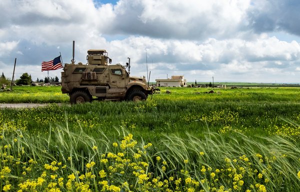 US soldiers patrol the countryside of Rumaylan in Syria's northeastern al-Hasakeh province near the border with Turkey on April 13. [Delil Souleiman/AFP]