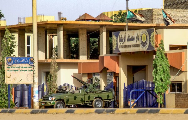 A truck mounted with a turret belonging to Sudan's Rapid Support Forces paramilitaries is stationed outside the offices of Dar al-Mushaf (African Holy Qur'an Publishing House) in the south of Khartoum on April 17. [AFP]